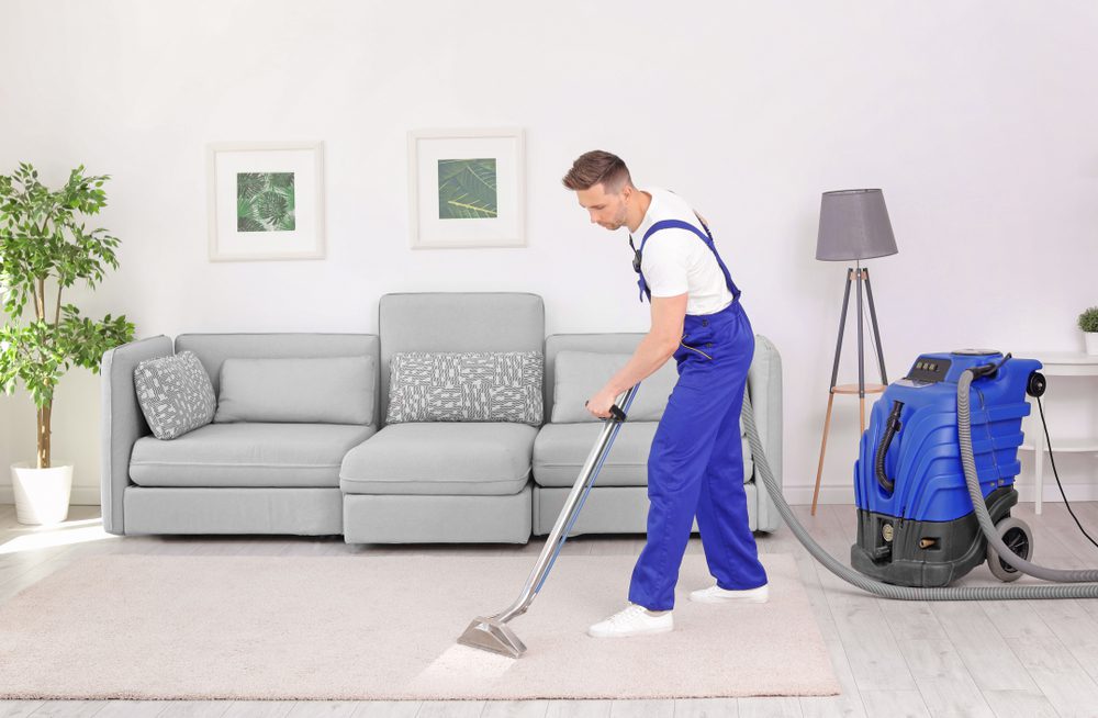 Male,Worker,Removing,Dirt,From,Carpet,With,Professional,Vacuum,Cleaner